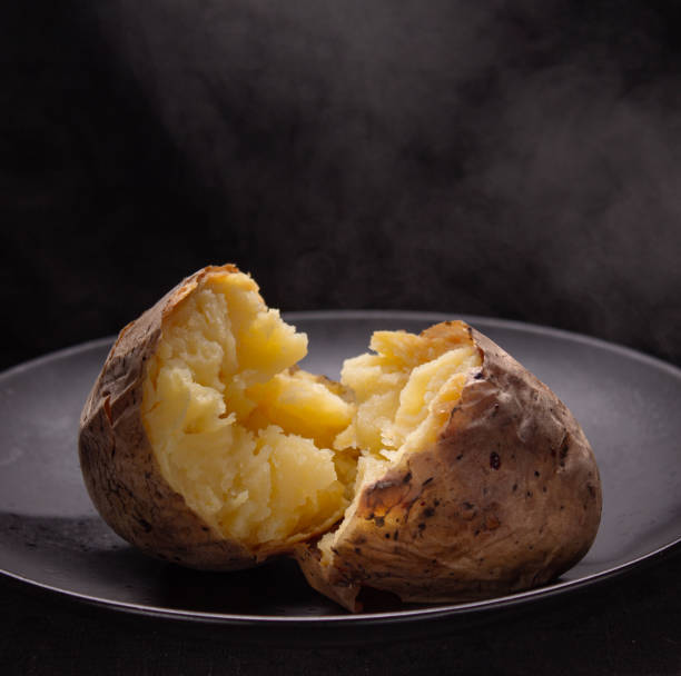 hot potato in peel on plate, copy space, selective focus