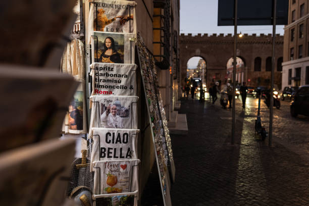 Rome, Italy, October 15, 2024: Traveling in Rome during the Jubilee Giubileo 2025 preparation. Gift shop with religious and traditional content, with Pope Francis t-shirt design aside the Monalisa with cats.