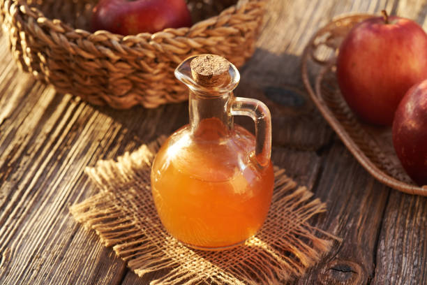 istock A jug of apple cider vinegar with fresh apples on a table in sunlight 2179538657