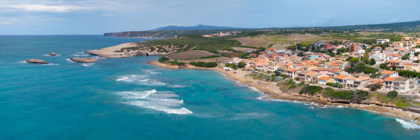 Aerial view of the picturesque village of S'Archittu on the coast of Sardinia, known for an arch-shaped rock.