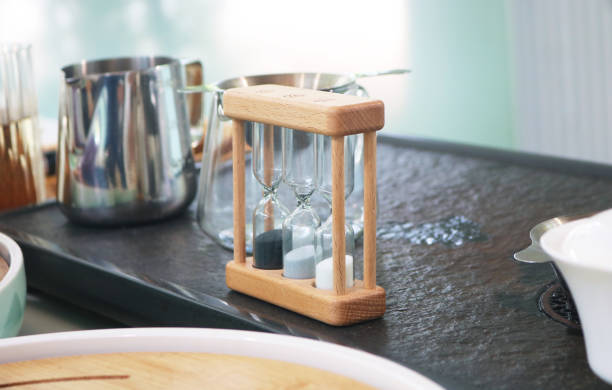 istock Wooden hourglass on coffee counter. 2179539988