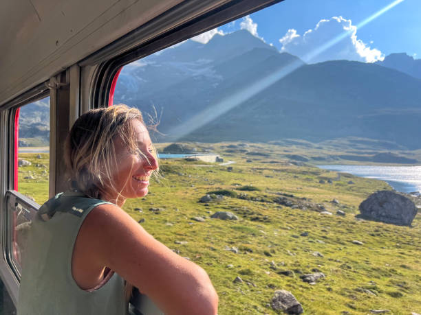 istock Woman Enjoying a Scenic Train Ride through Alpine Meadows 2179542736