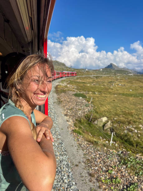 istock Woman Enjoying a Scenic Train Ride through Alpine Meadows 2179542740