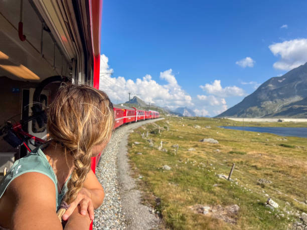 istock Woman Enjoying a Scenic Train Ride through Alpine Meadows 2179542741
