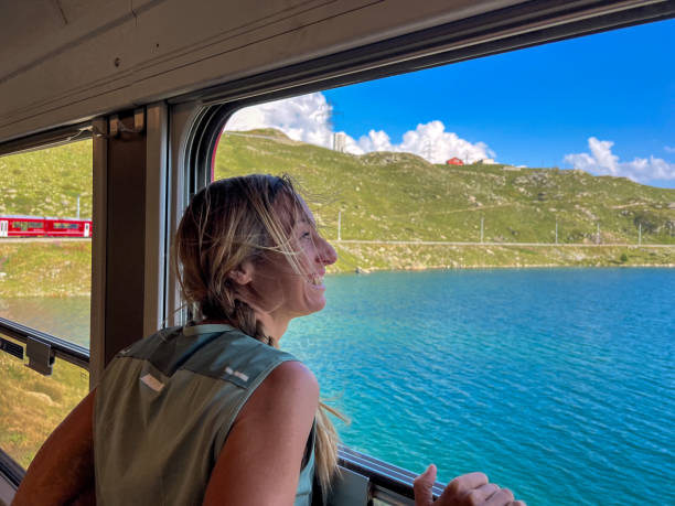 istock Woman Enjoying a Scenic Train Ride through Alpine Meadows 2179542762