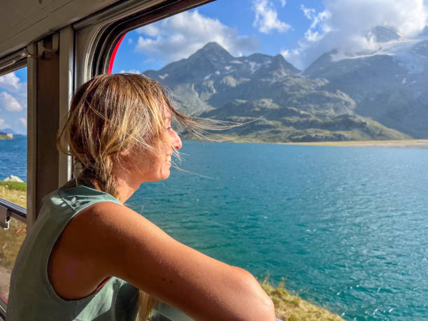 istock Woman Enjoying a Scenic Train Ride through Alpine Meadows 2179542763