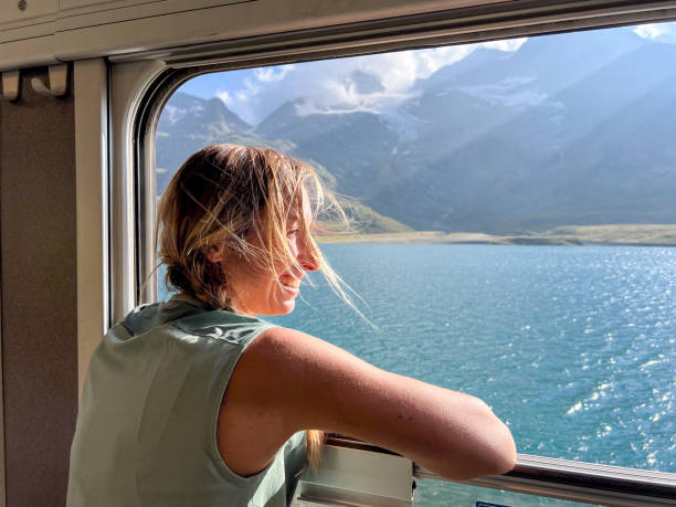 istock Woman Enjoying a Scenic Train Ride through Alpine Meadows 2179542764