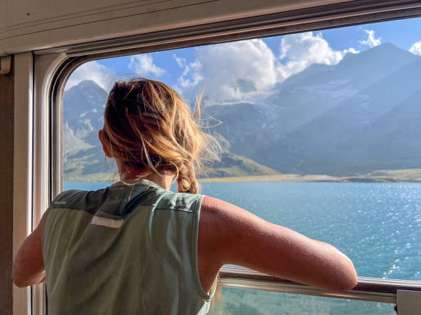 istock Woman Enjoying a Scenic Train Ride through Alpine Meadows 2179542768