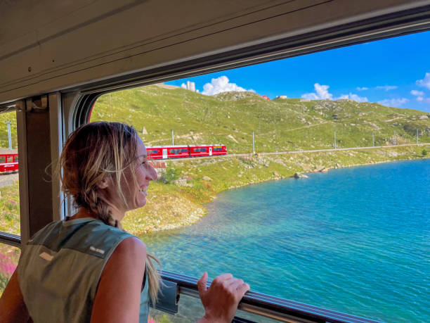 istock Woman Enjoying a Scenic Train Ride through Alpine Meadows 2179542781