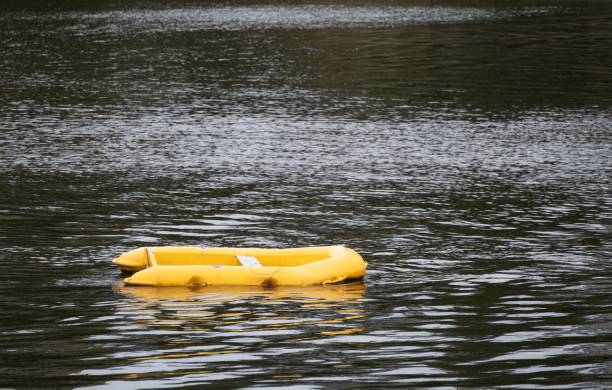 istock Solitary yellow dinghy floating peacefully on a calm river 2179545060