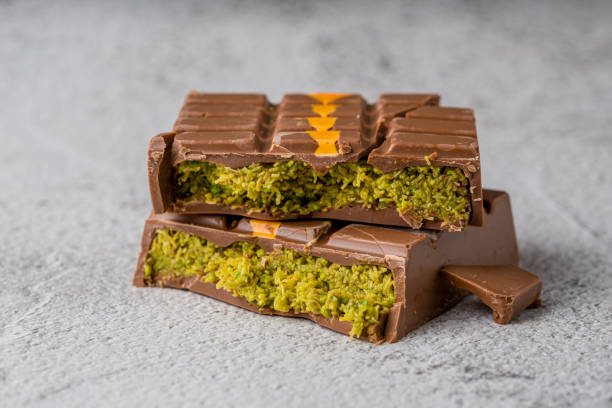 istock Dubai Chocolate bar with green kadayif and peanut butter on white stone table 2179551803