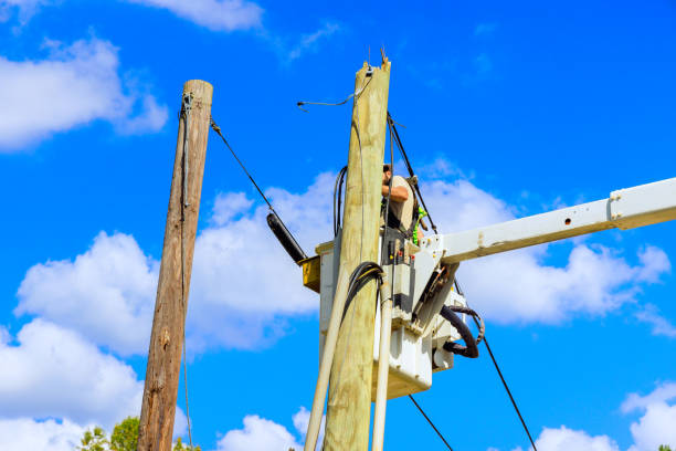istock Electrician working on electric power system after hurricane using hydraulic tower mounted bucket mounted on a truck. 2179554330