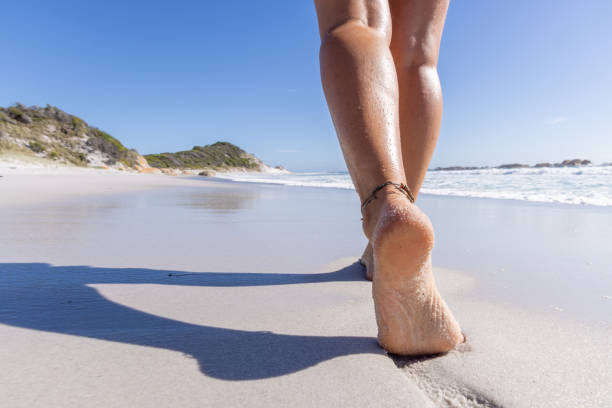 istock Sand Between Her Toes: Woman's Feet on Beach Walk 2179560535