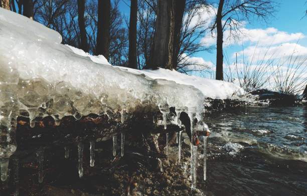 Icicle, dirty ice stalactite sharpened downward when melting dirty snow
