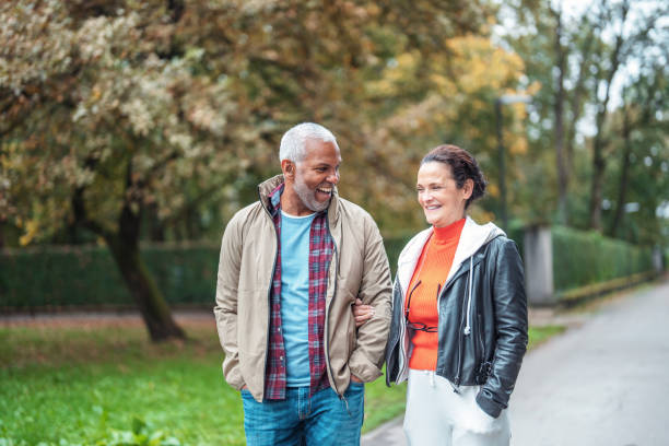 Mature Couple Enjoys Leisurely Stroll in Park