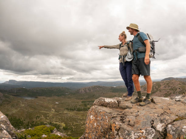 istock Adventurous Couple Pointing from Mountain Top 2179569358