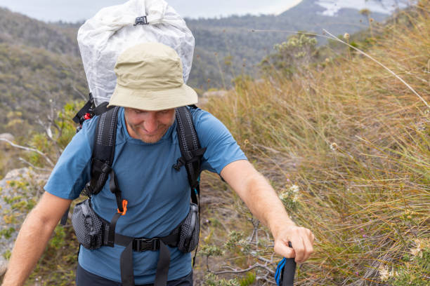 istock Male Hiker with Trekking Pole Climbing Mountain Trail 2179580742