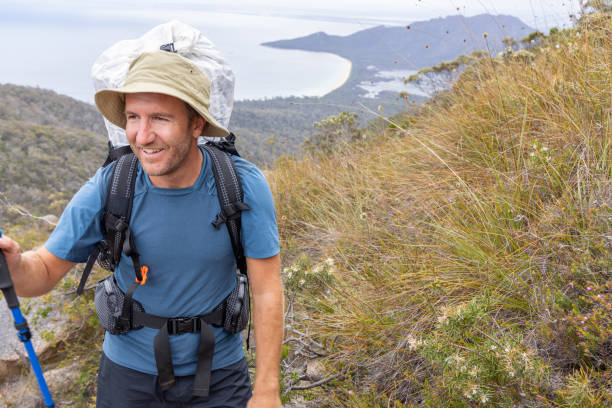 istock Male Hiker with Trekking Pole Climbing Mountain Trail 2179580755