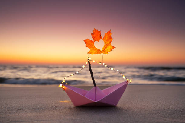 istock autumn leaf on a paper boat 2179587338