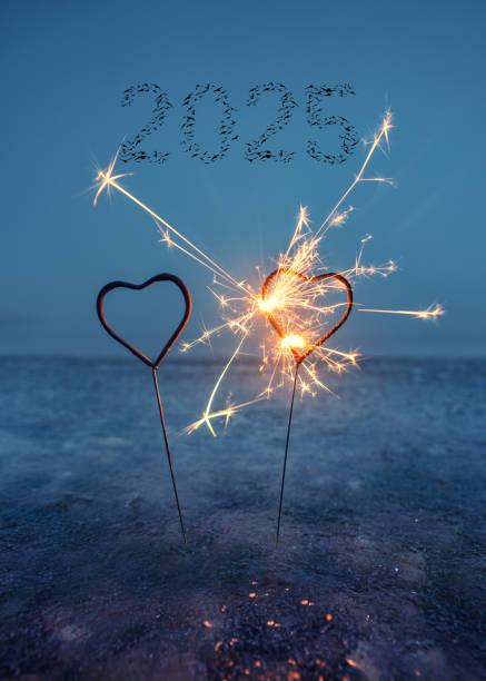 bright shining heart sparklers in the sea with birds flying in shape of 2025
