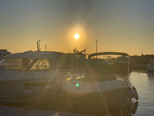 Fantastic yellow sunset in the marina. Sailing boats.