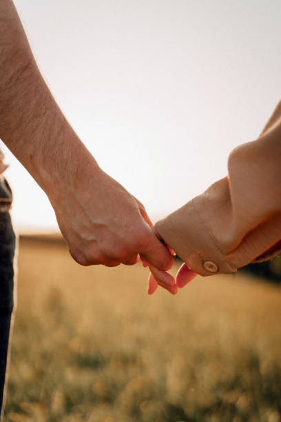 istock Hands reaching out during sunset in a peaceful field 2179589603