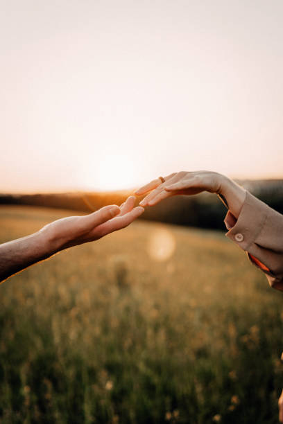 istock Hands reaching out during sunset in a peaceful field 2179589618