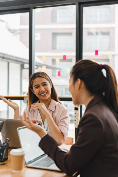 istock Engaged women discussing ideas in modern office setting, showcasing collaboration and teamwork. Their expressions reflect enthusiasm and positivity, enhancing work environment 2179592163