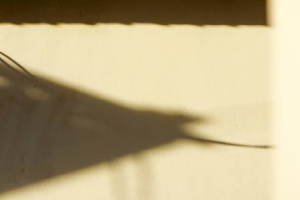 istock shadows and light on the wall, for the background 2179592374