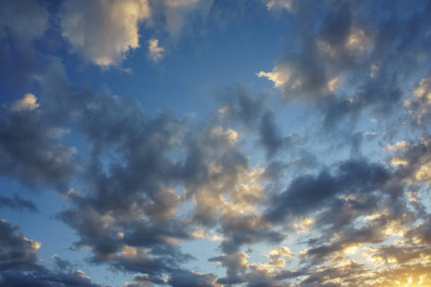 istock A breathtaking sky filled with vibrant clouds during twilight, showcasing a beautiful gradient as the sun begins to set on a serene evening 2179592903