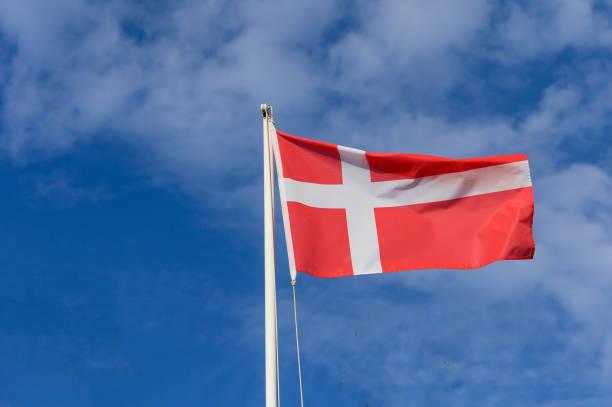 istock A vibrant Danish flag billows against a bright blue sky, symbolizing national pride and history in Denmark during a sunny day 2179592919