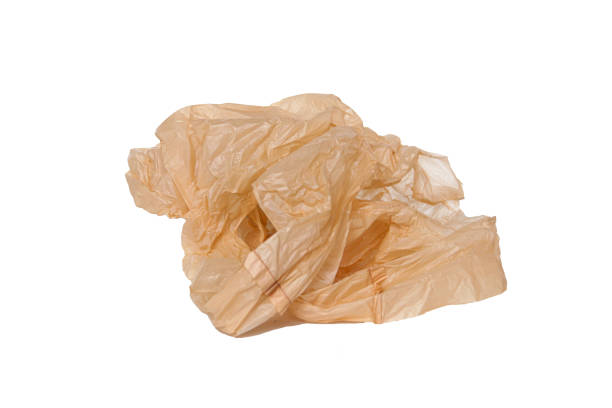 istock Crumpled beige plastic bag isolated on white background, perfect for concepts on pollution, recycling, and waste management 2179593567