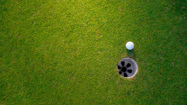 istock Golf ball on green grass in the evening golf course with sunshine background. 2179593786