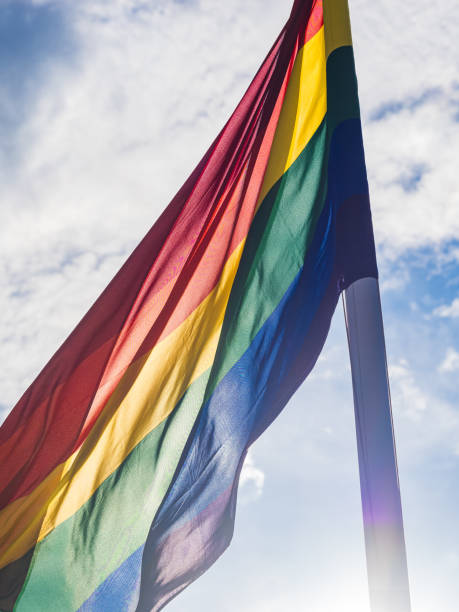 istock Colorful Pride Flag Waves in Sky with Billowing Clouds and Wind 2179594286