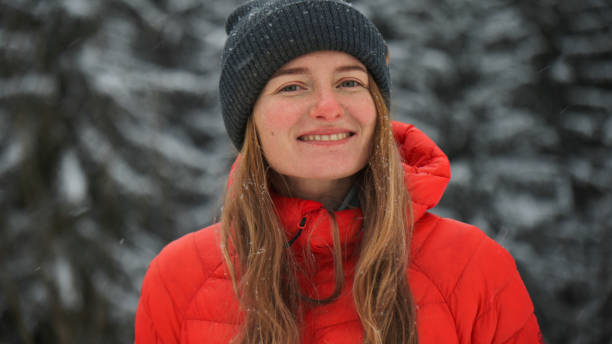 Young woman prepares for hike in winter, Carpathian Mountains