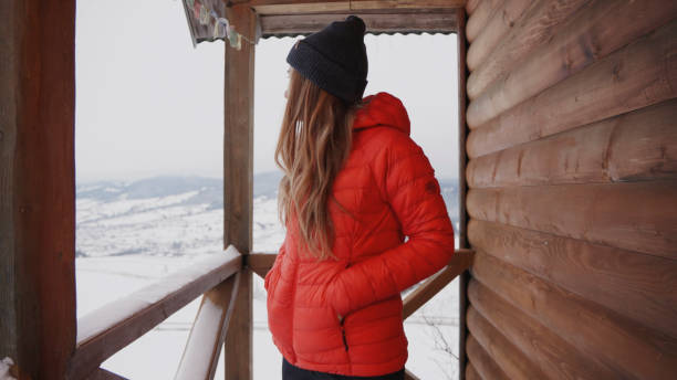 Young woman prepares for hike in winter, Carpathian Mountains