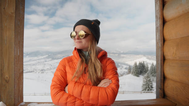Young woman prepares for hike in winter, Carpathian Mountains