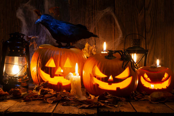 istock Halloween Jack-o-Lantern Pumpkins on rustic wooden background 2179598631