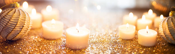 istock Christmas balls with candles surrounded by golden confetti 2179598708