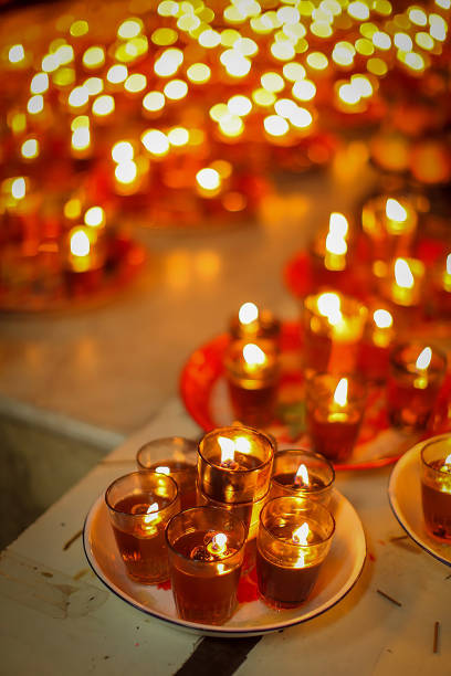 istock Stunning array of glowing candles forming rows and casting warm light, ideal for creating a peaceful and spiritual ambiance. Perfect for meditation, reflection, or romantic settings 2179599221