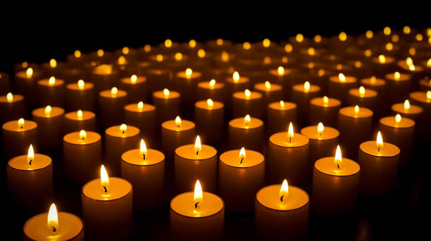 Stunning array of glowing candles forming rows and casting warm light, ideal for creating a peaceful and spiritual ambiance. Perfect for meditation, reflection, or romantic settings