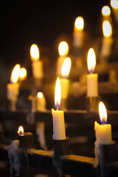 Stunning array of glowing candles forming rows and casting warm light, ideal for creating a peaceful and spiritual ambiance. Perfect for meditation, reflection, or romantic settings
