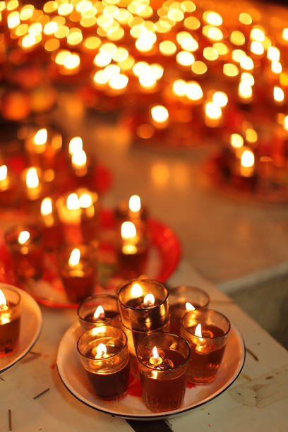 istock Stunning array of glowing candles forming rows and casting warm light, ideal for creating a peaceful and spiritual ambiance. Perfect for meditation, reflection, or romantic settings 2179599302