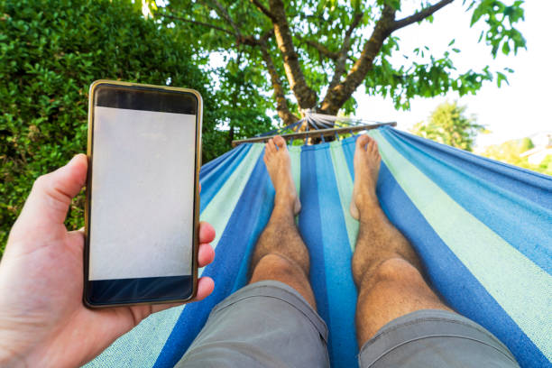 Personal perspective of a person using smartphone while enjoying relaxation
