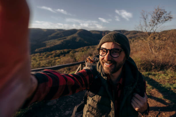 istock Shot of a young man taking selfies while hiking up a mountain 2179608803