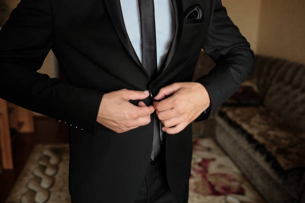 istock A man fastens the buttons on his jacket. 2179609875