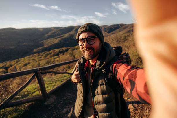 istock Shot of a young man taking selfies while hiking up a mountain 2179610039