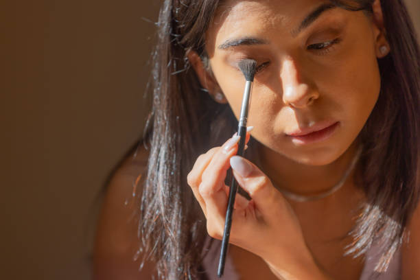 istock Young woman is doing eye make-up. 2179612261