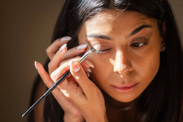 istock Young woman is applying eyeliner. 2179612578