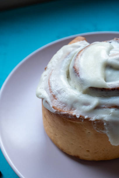 Cinnamon roll, a northern European dessert, on a box and blue ground  in close-up